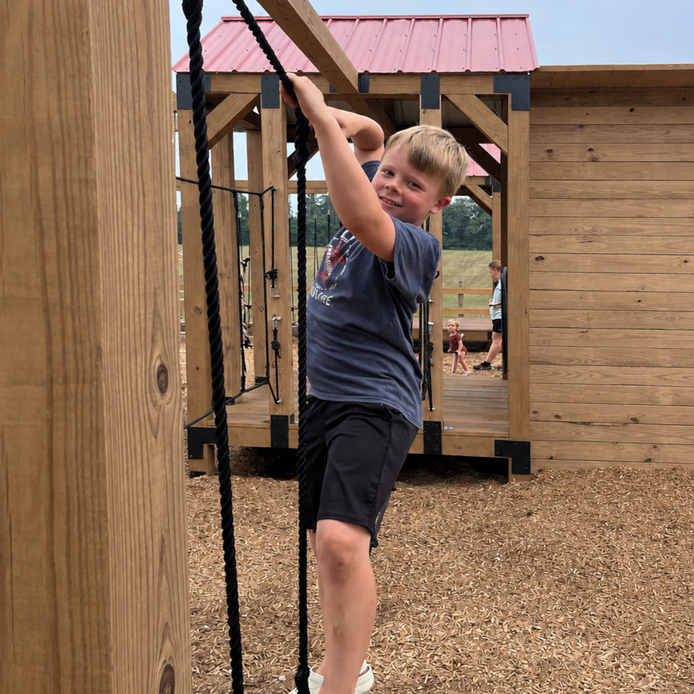Boy on rope playground